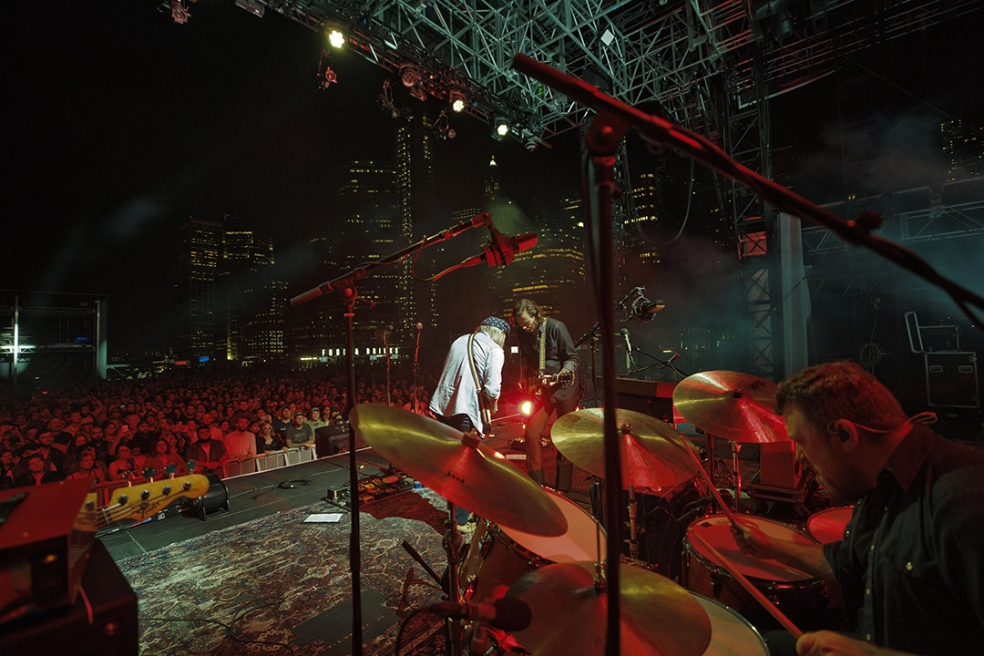 Leon Power playing drums outdoors in a city